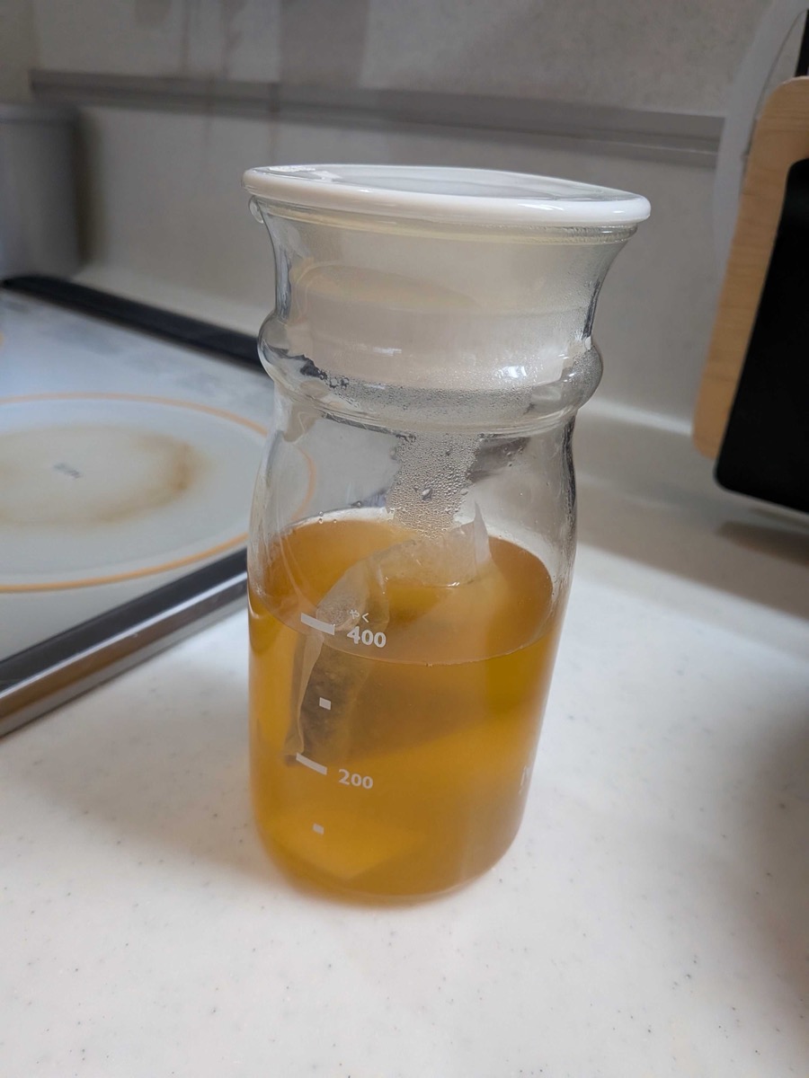 Dashi broth stored in a glass measuring jug in the kitchen