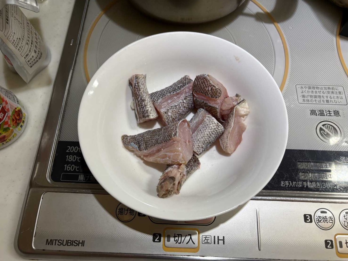 Kochi flathead fish cut into pieces on a white plate