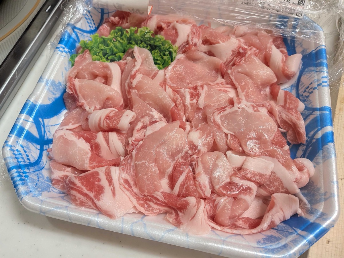 Raw thinly sliced shabu-shabu pork on a tray