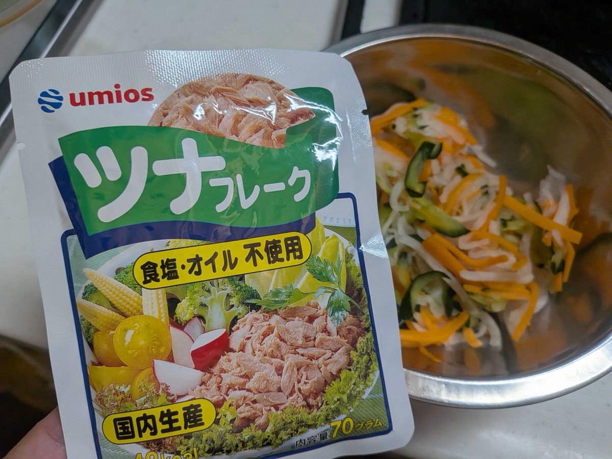 A pouch of Japanese tuna flakes next to the bowl of squeezed vegetables