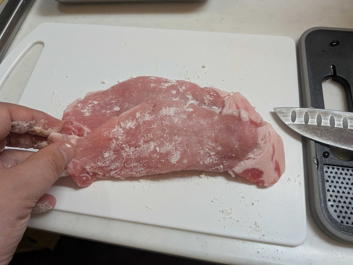 A thin pork loin steak dusted with a light coating of flour