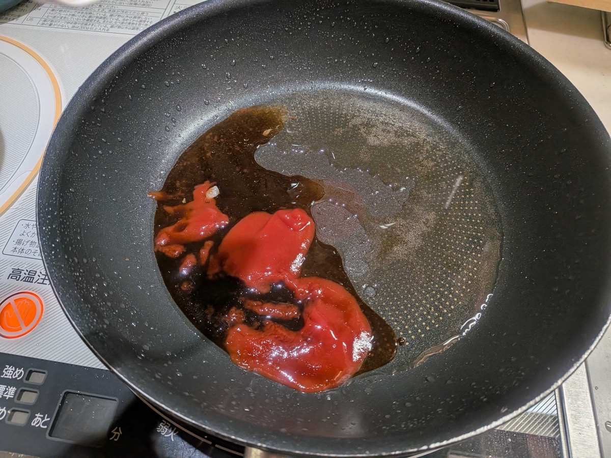 Ketchup and Worcestershire sauce simmering together in the pan to make hamburg sauce