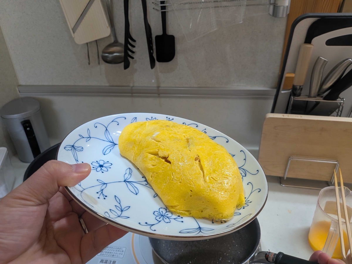 A plated omurice omelette before adding ketchup on top