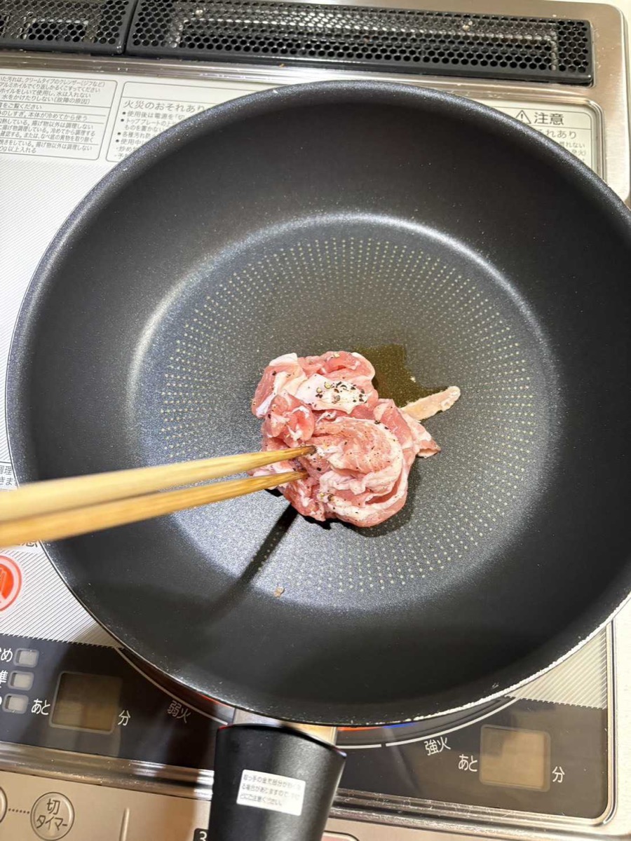 Seasoned pork belly stir-frying in a pan