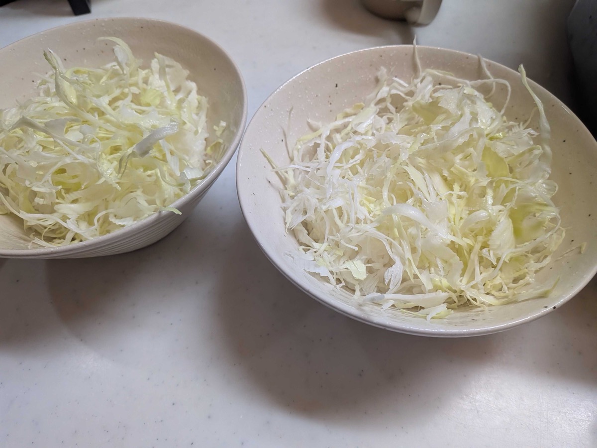 Shredded cabbage layered over rice in two bowls