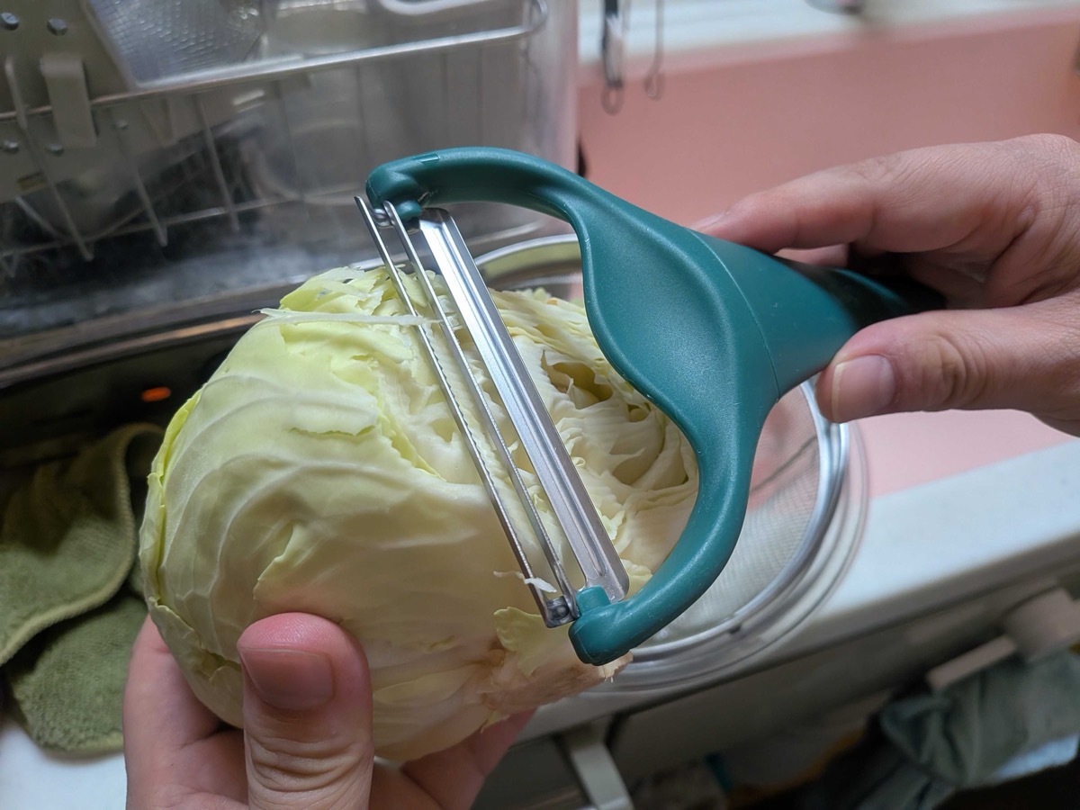 Shredding cabbage into fine strips with a green cabbage slicer
