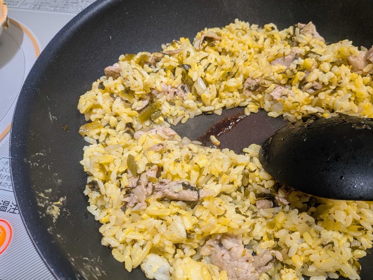 Finished takana chahan in the pan — golden fried rice tossed evenly with pickled mustard greens and pork