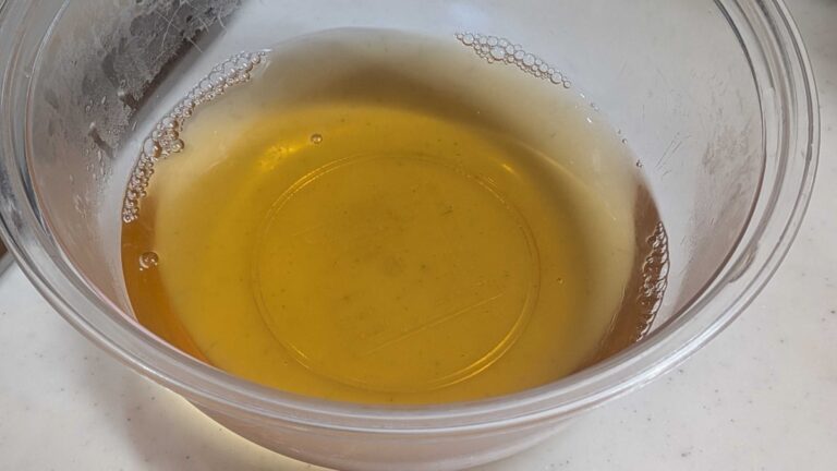 Finished ichiban dashi — clear golden Japanese soup stock in a glass bowl