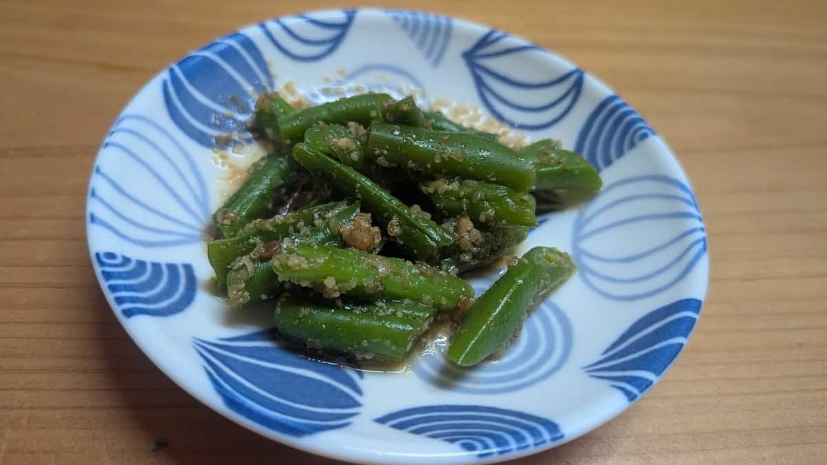 Goma ae green beans plated as a small side dish on the dinner table