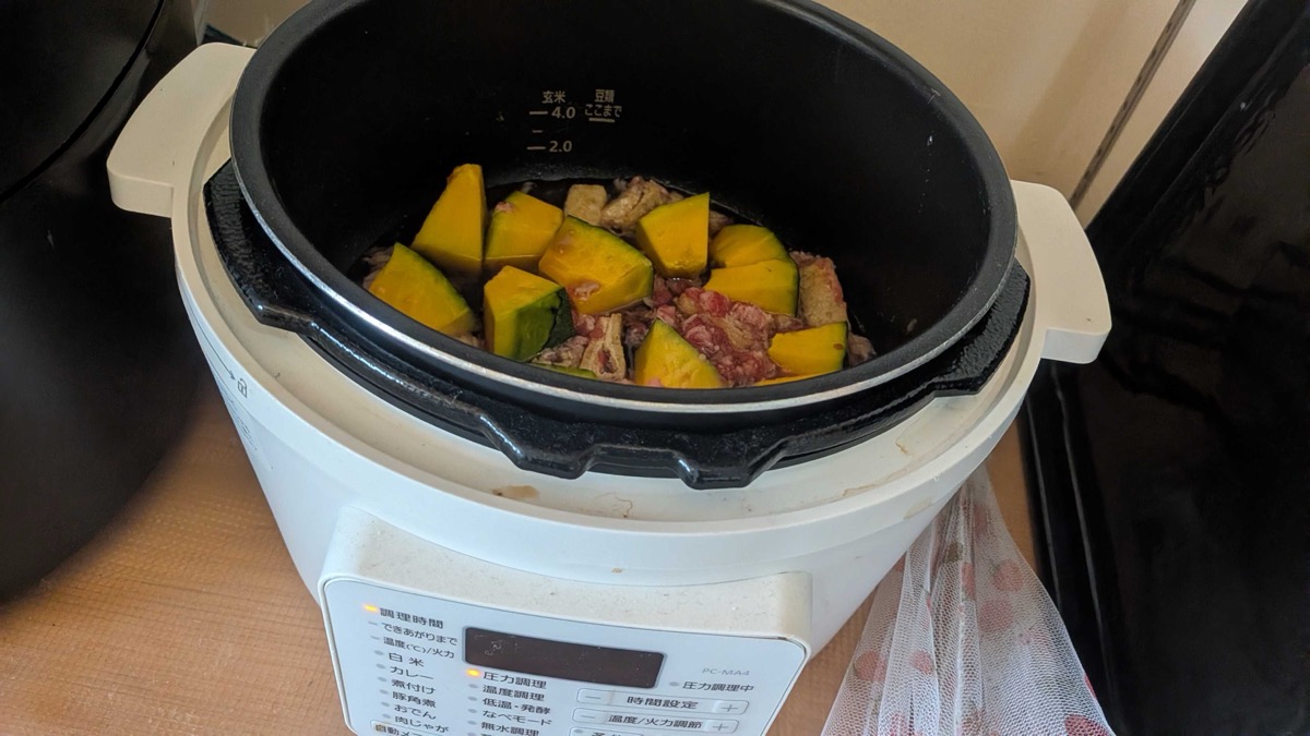 The inner pot of kabocha and beef set into the Iris Ohyama electric pressure cooker