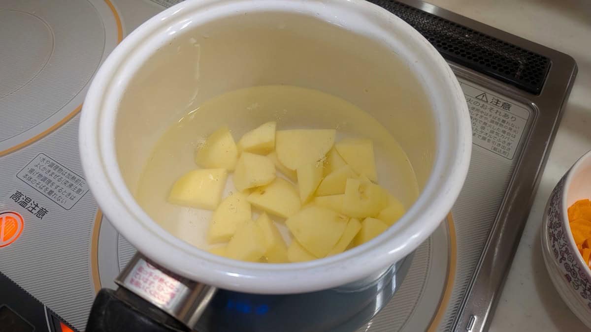 Potato chunks boiling in a pot of water