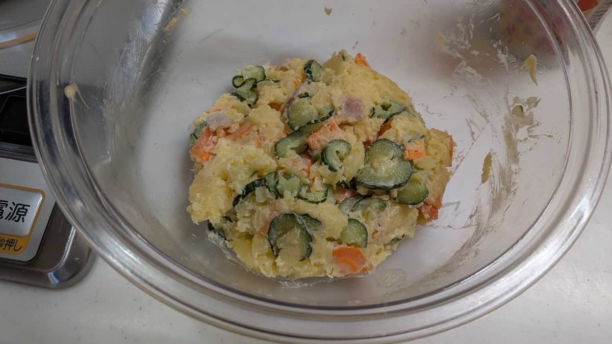 Finished Japanese potato salad mixed together in a glass bowl