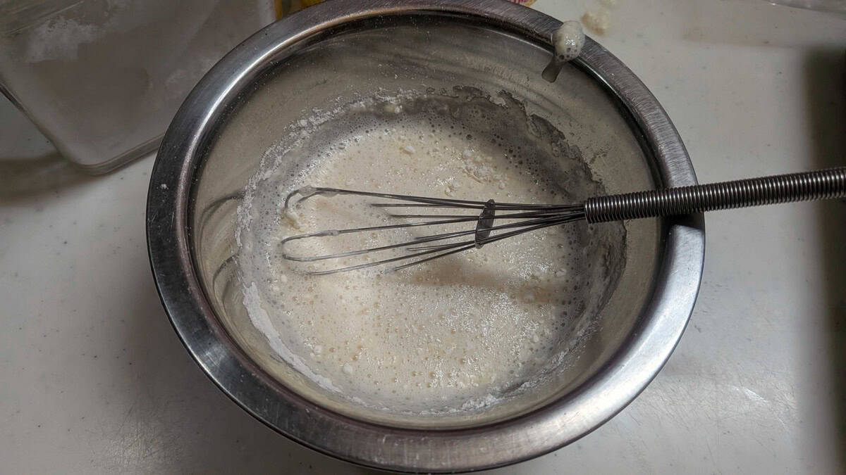 The light, airy tori ten tempura batter mixed in a bowl with a whisk