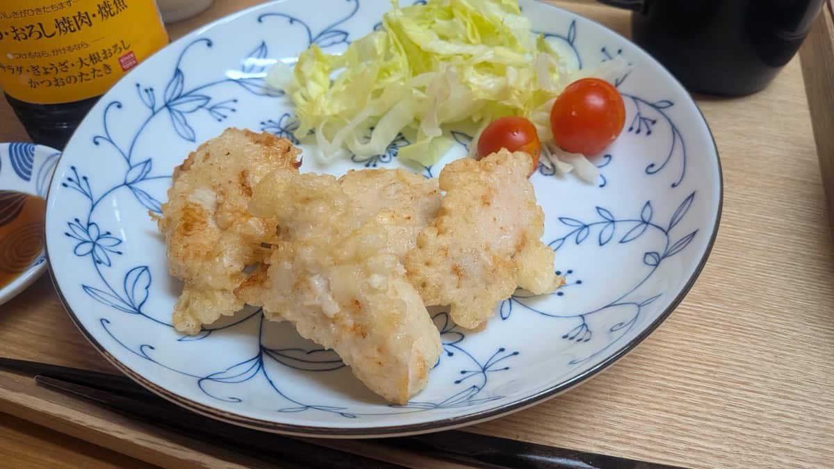 Close-up of crispy golden tori ten chicken tempura pieces on a plate