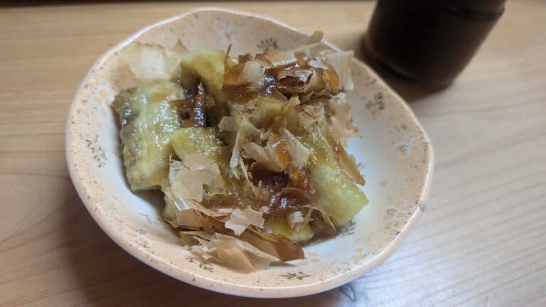 Yaki nasu — Japanese grilled eggplant in a small bowl, topped with bonito flakes and ponzu