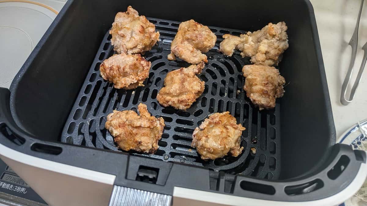 Golden, crisp air fryer karaage in the air fryer basket right after cooking