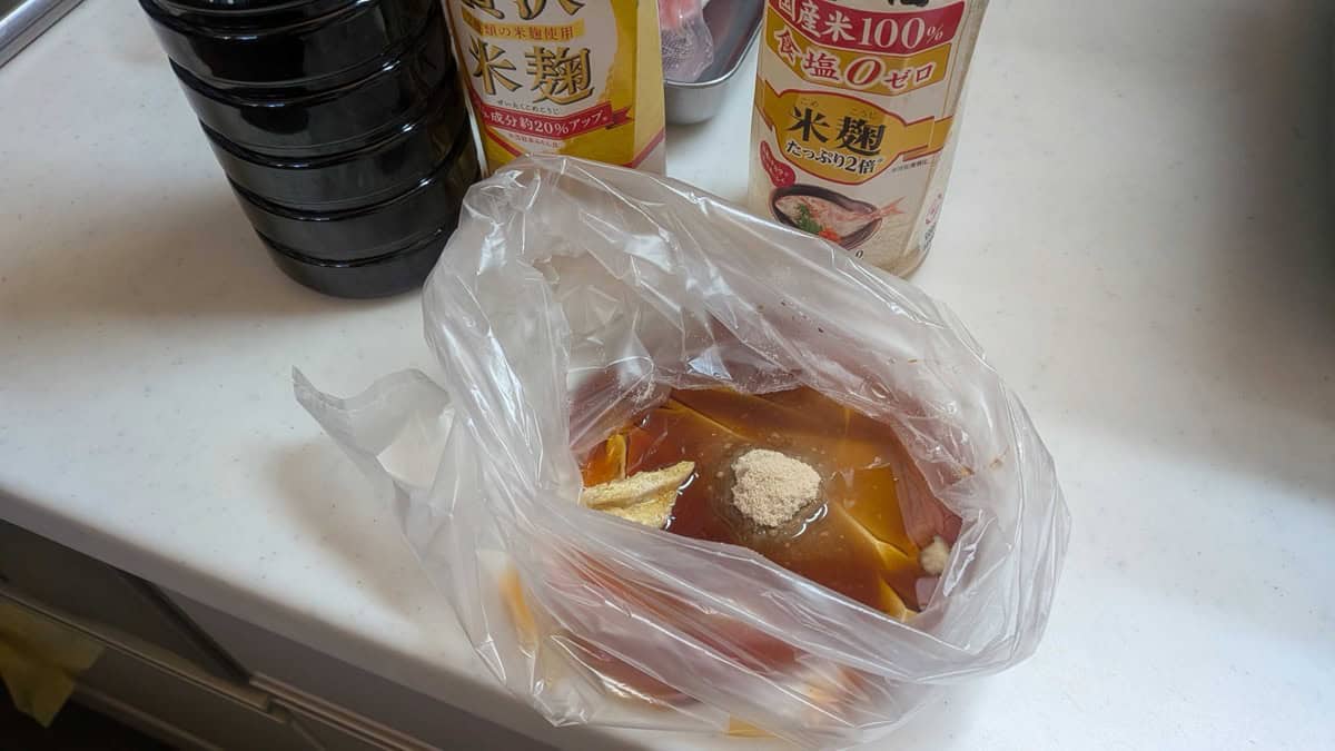 Soy sauce, mirin, sake, sugar, garlic and ginger paste mixed in a freezer bag on a kitchen counter