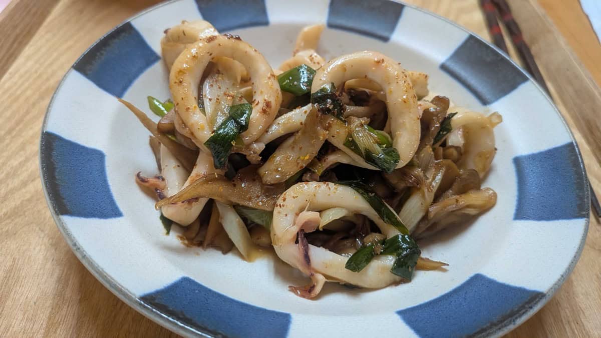 Close-up of the squid rings coated in butter and soy sauce with ichimi togarashi sprinkled over