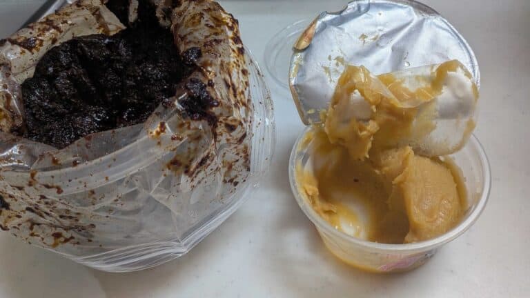 Dark homemade Japanese miso next to a tub of pale Kyoto shiro miso, showing the difference in color between long-fermented and short-fermented miso