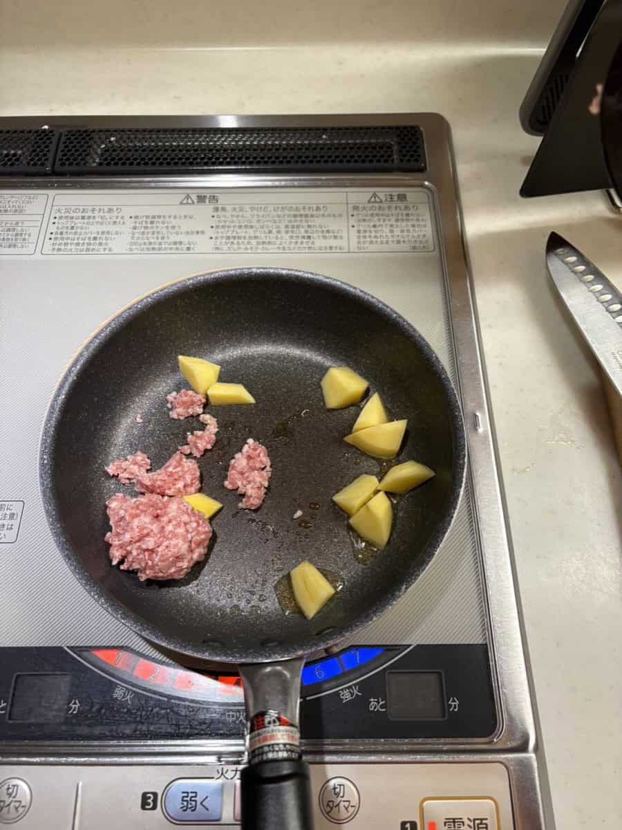Ground pork and chunks of potato just added to the frying pan together