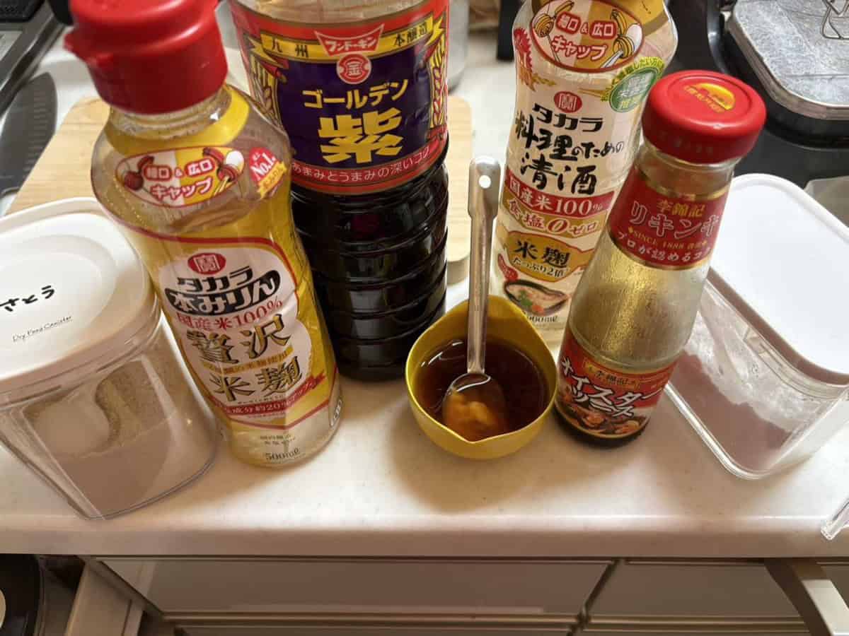 The sauce ingredients lined up — sugar, hon-mirin, Kyushu soy sauce, cooking sake, oyster sauce and potato starch, with the mixed sauce in a small yellow bowl